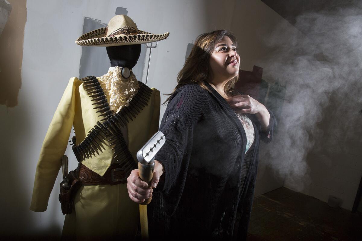 Artist Nao Bustamante will be showing works tied to her project about women and the Mexican Revolution at the Vincent Price Art Museum at East L.A. College. She is seen here with a period-style dress made from Kevlar.