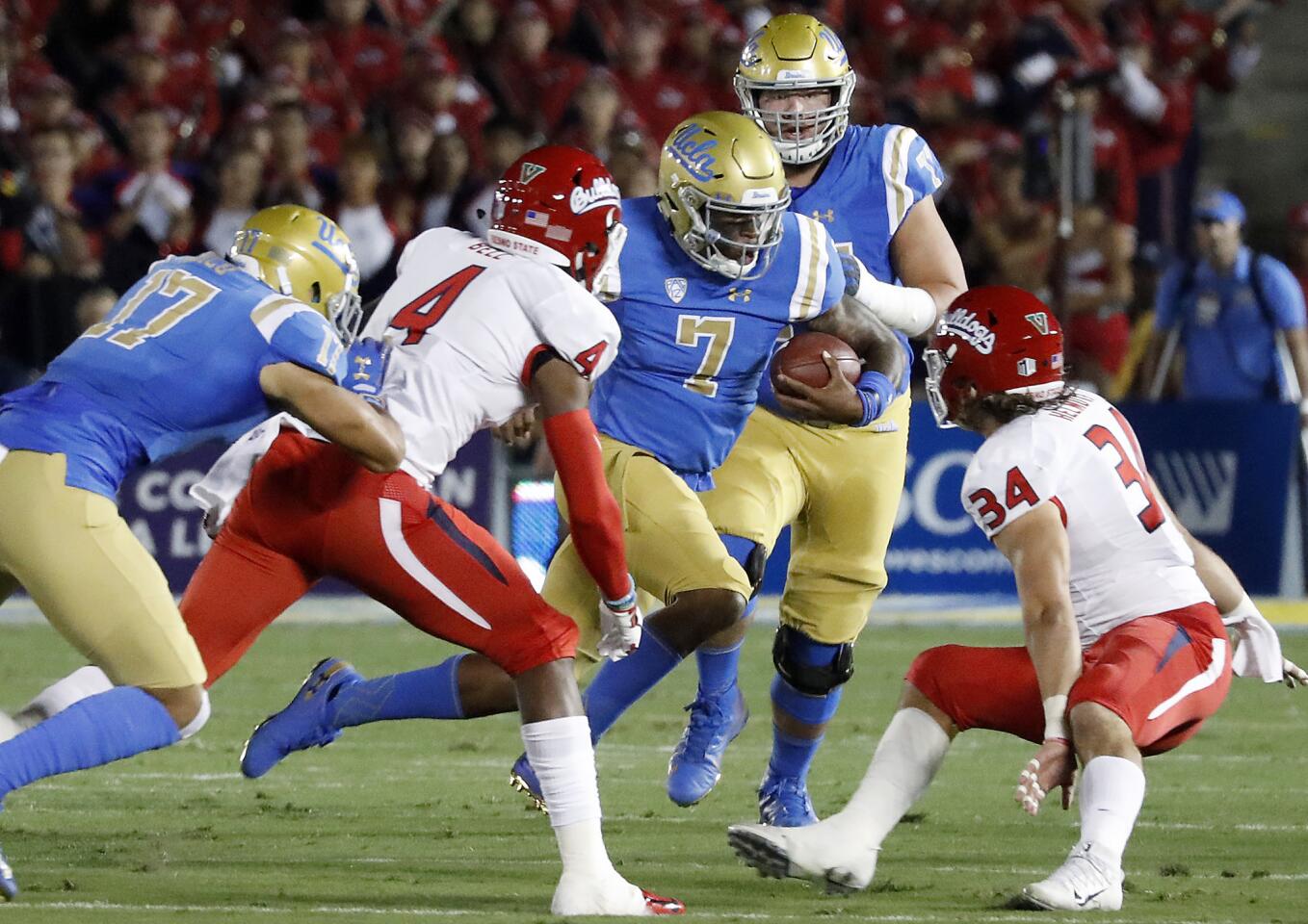 UCLA quarterback Dorian Thompson-Robinson (7) looks for room to run against Fresno State in the first quarter on Saturday at the Rose Bowl.