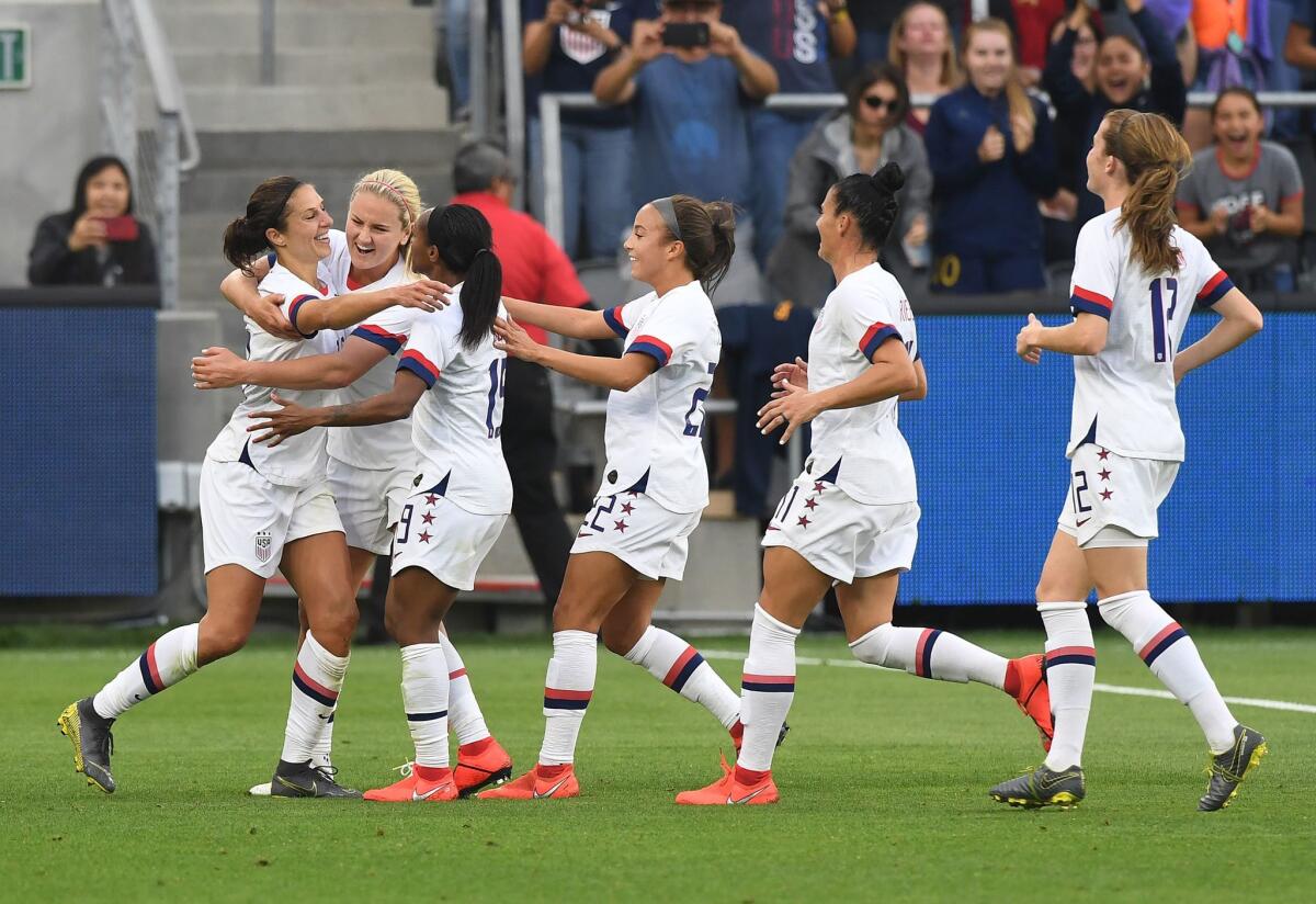 The US's Carli Lloyd (L) celebrates with teammates after scoring a goal against Belgium during the International Women's friendly football match between the US and Belgium at the Banc of California Stadium in Los Angeles on April 7, 2019.
