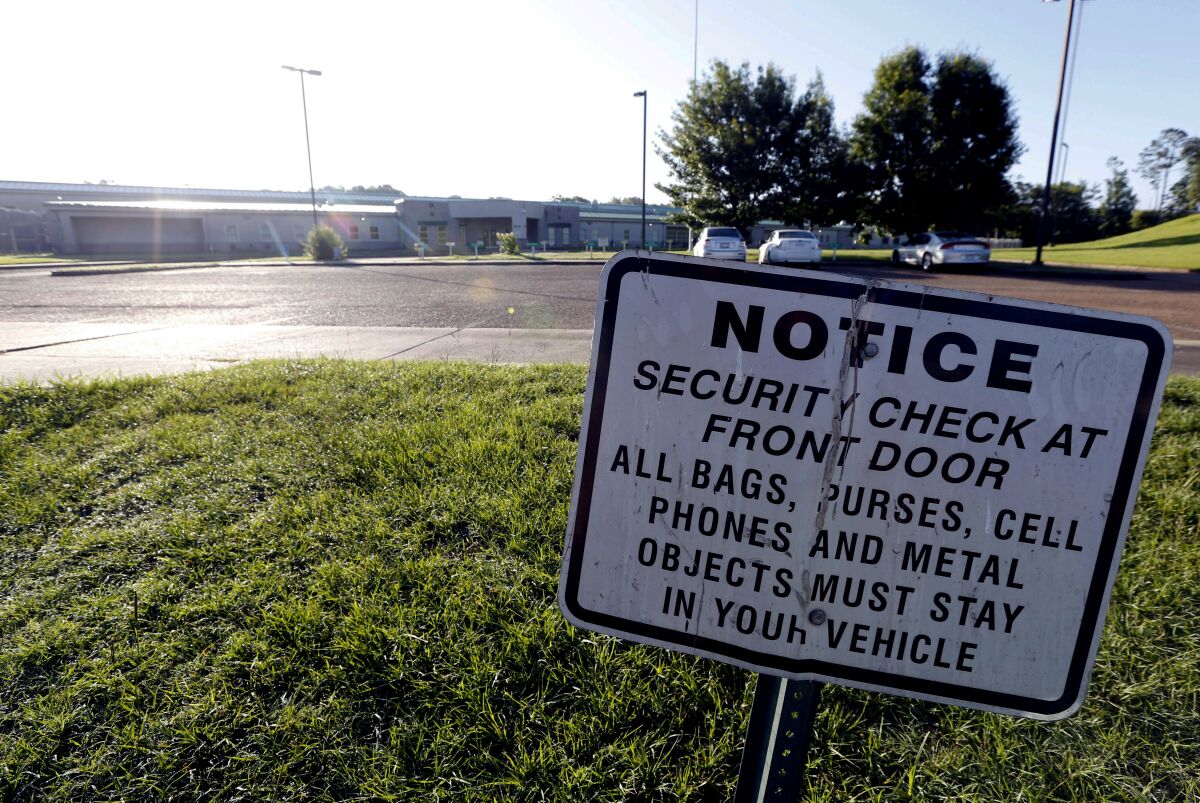 FILE - A security notice is posted outside the Hinds County Detention Center in Raymond, Miss., on June 12, 2015. A federal judge has issued a civil contempt order over conditions at the detention center. U.S. District Judge Carlton Reeves wrote Friday, Feb. 4, 2022, that Hinds County officials have failed to fix problems in the jail that has experienced violence and lax security. (AP Photo/Rogelio V. Solis, File)