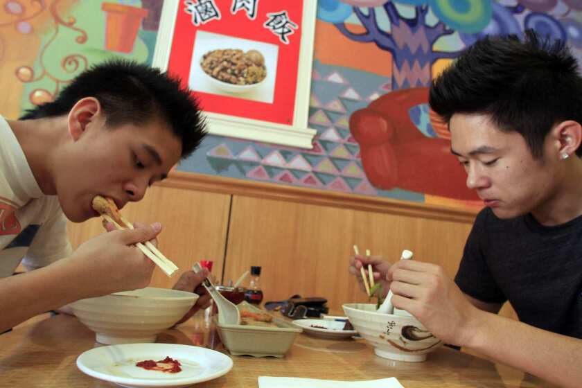 Jason Wei, 18, left, and Raymond Tang, 18, having their lunch.