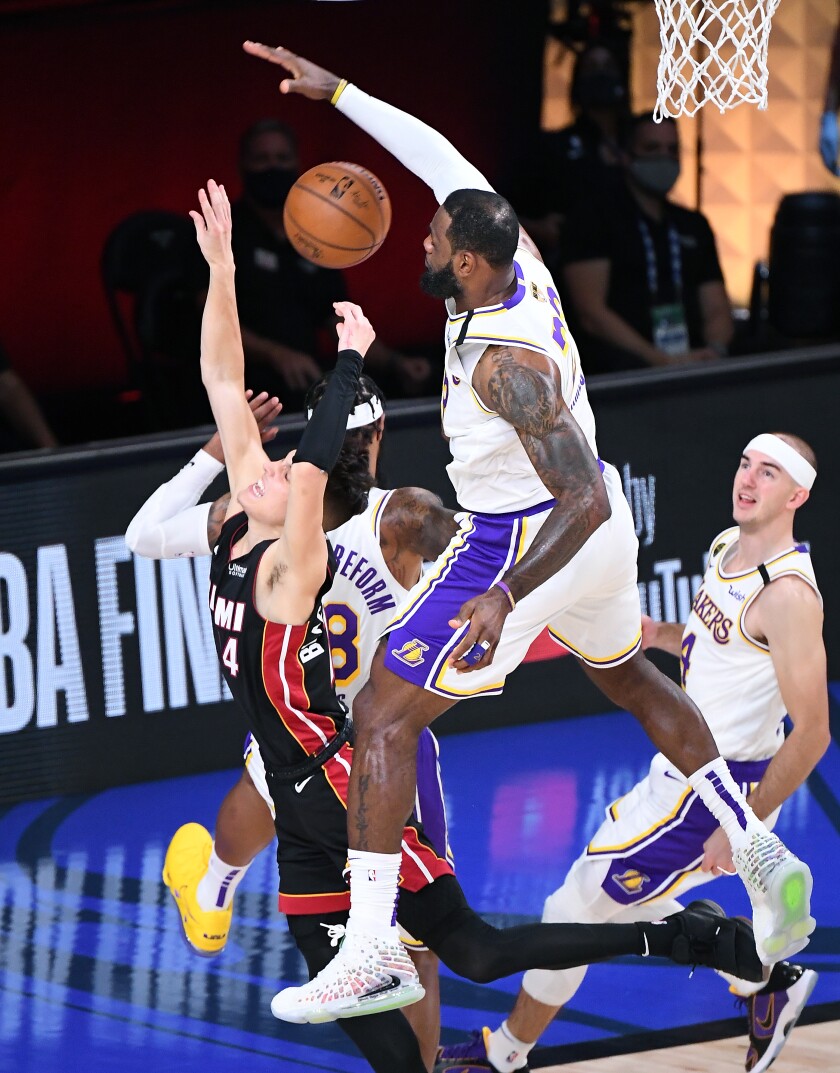 Lakers forward LeBron James blocks a shot by Heat guard Tyler Herro during Game 3.