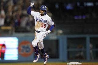 Los Angeles Dodgers' Mookie Betts celebrates as he runs the bases on a three-run home run during the eighth inning of the team's baseball game against the San Francisco Giants on Thursday, July 21, 2022, in Los Angeles. (AP Photo/Marcio Jose Sanchez)