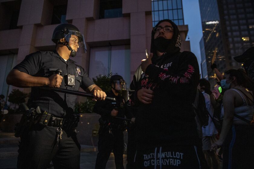 Los Angeles, CA, Thursday, May 28, 2020 - Dozens of protestors, many with the Black Lives Matters movement, stand off with police on Grand Ave., downtown, in response to the death of George Floyd. (Robert Gauthier / Los Angeles Times)