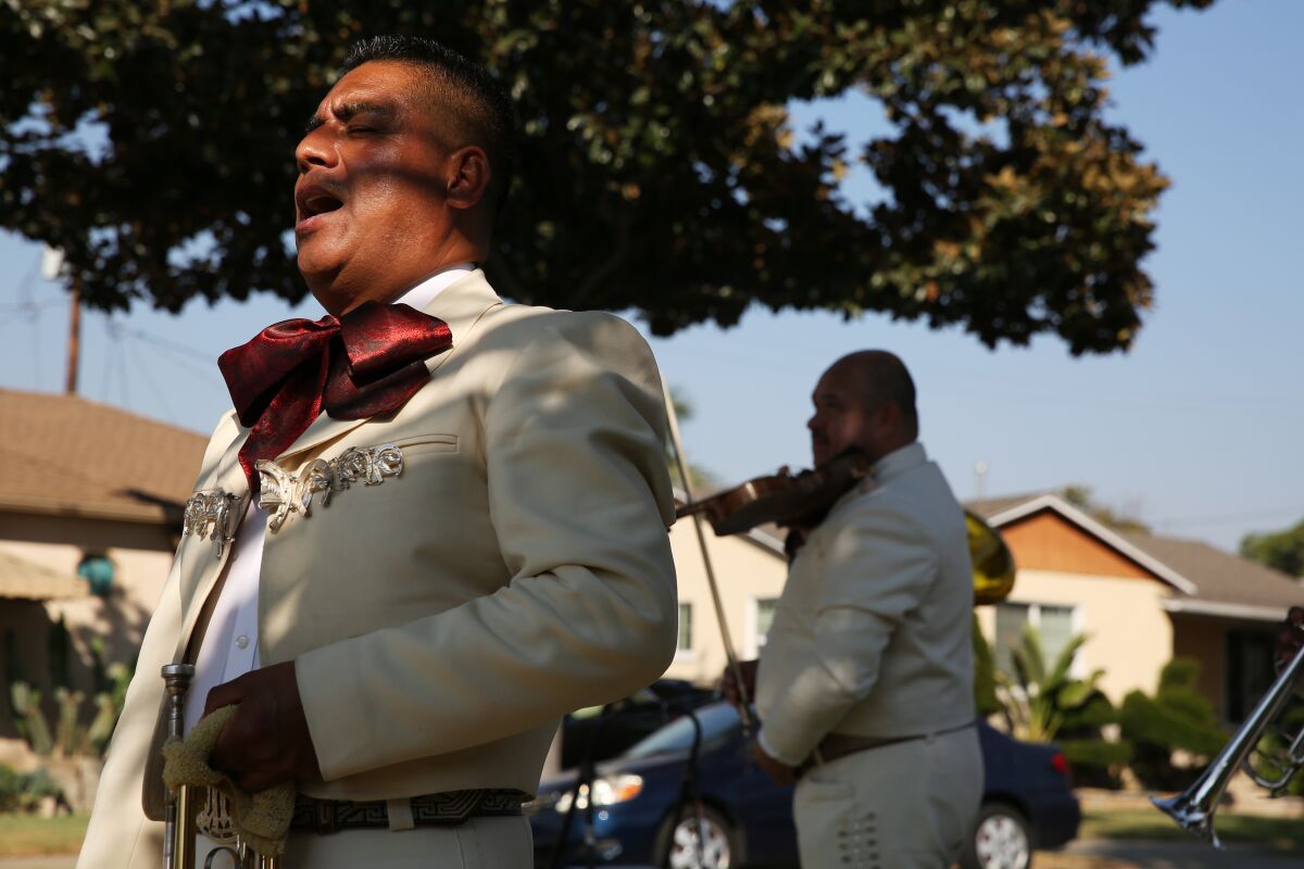 A mariachi band plays during Angelita Arellano's 98th birthday in East Los Angeles.