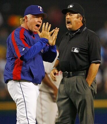 Texas Rangers manager Buck Showalter, left, argues with second base umpire Tim Tschida about a safe call at second base in the eighth inning.