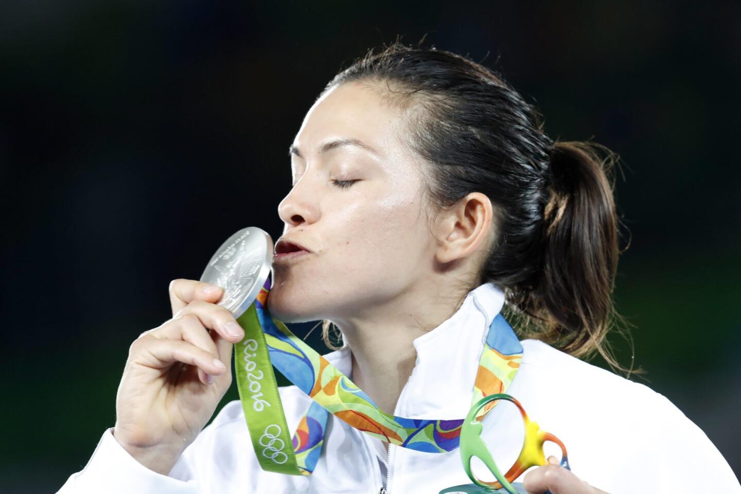 Silver medalist Maria Del Rosario Espinoza Espinoza of Mexico kisses her medal during the awards ceremony in the women's +67kg bout of the Rio 2016 Olympic Games Taekwondo events at the Carioca Arena 3 in the Olympic Park in Rio de Janeiro.