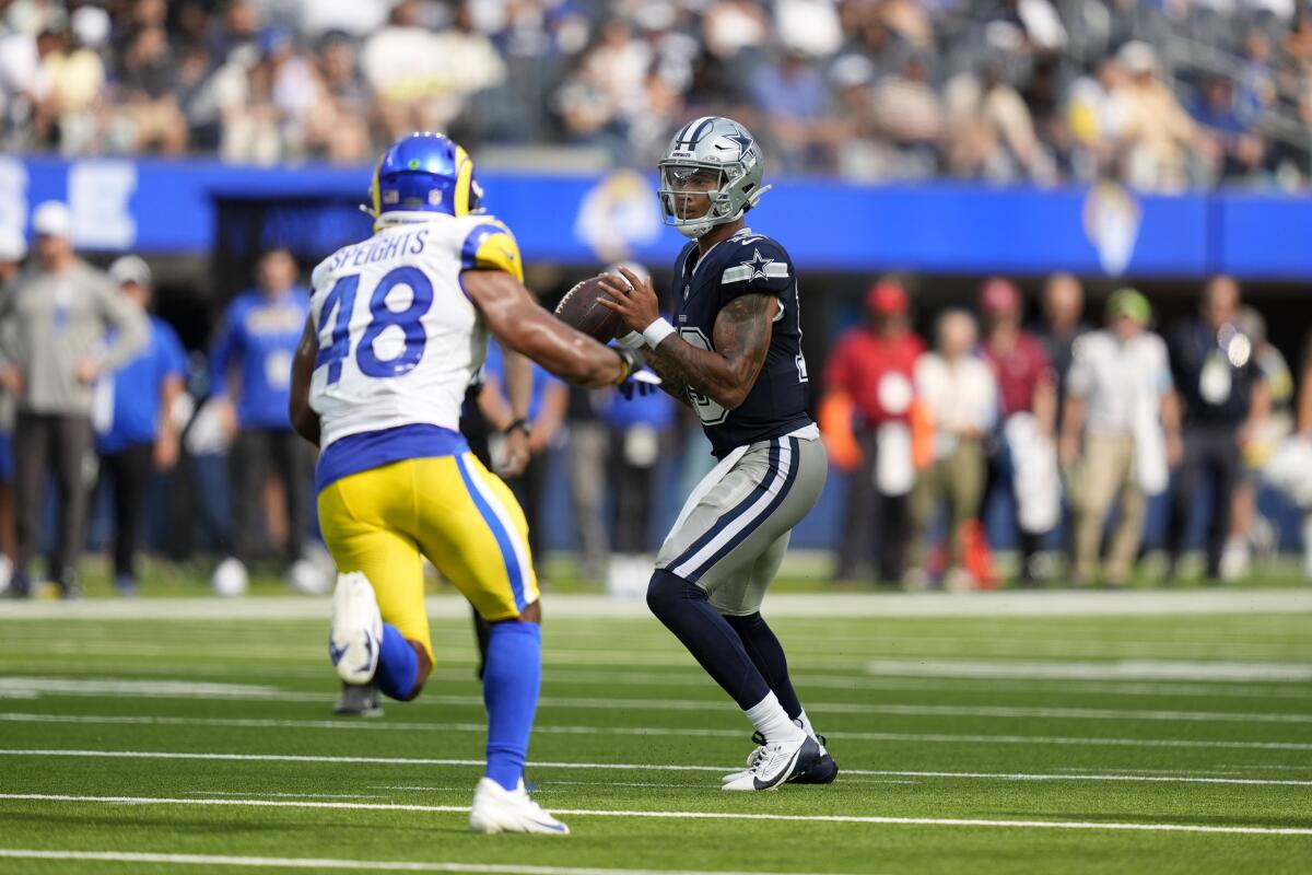 Rams linebacker Omar Speights (48) rushes Cowboys quarterback Trey Lance during their preseason game.