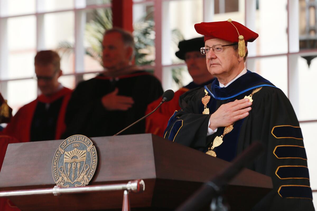 USC President C.L. Max Nikias, shown attending the university's commencement ceremony May 11, has agreed to step down.