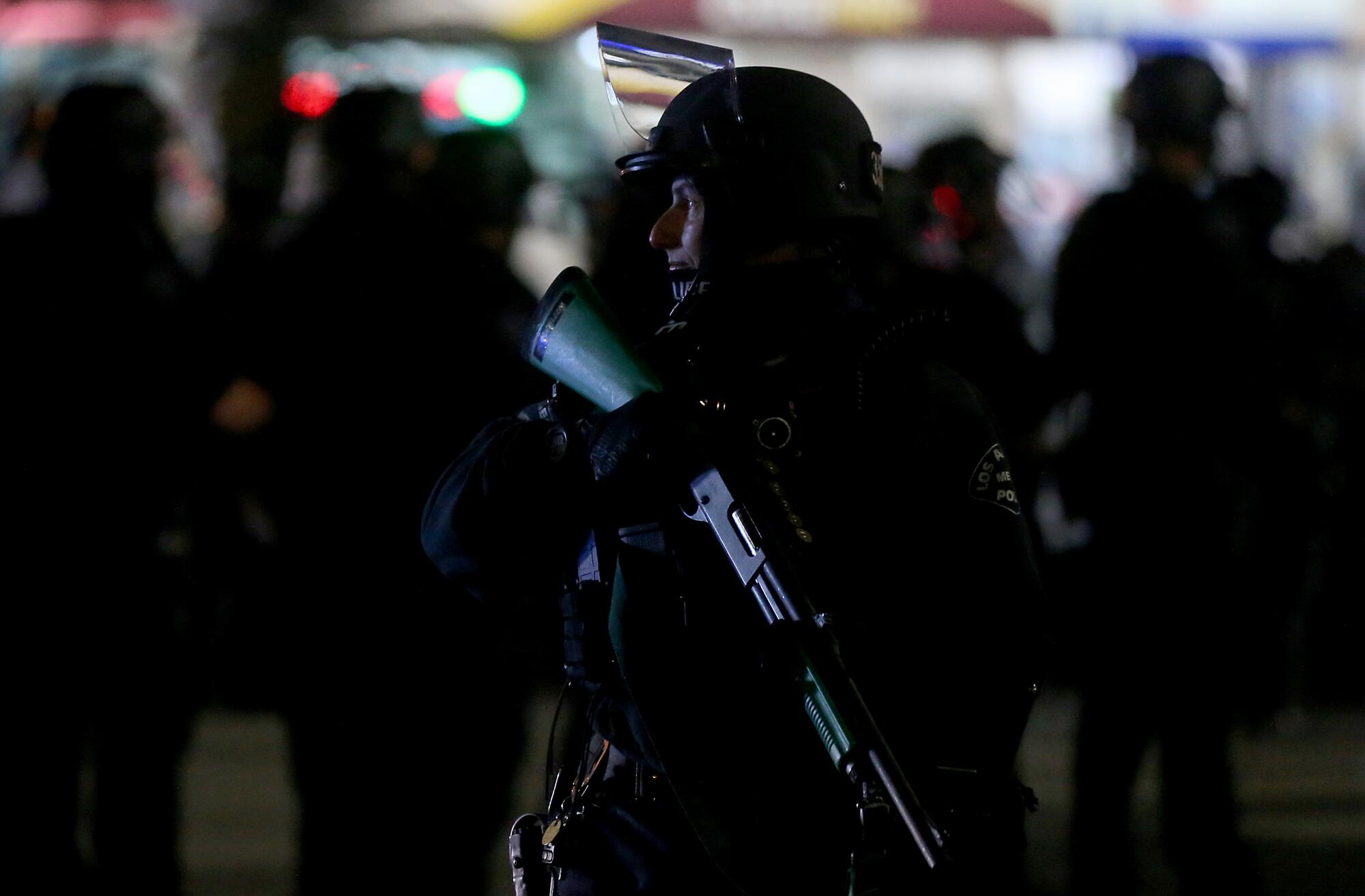 Police clear the intersection of Washington Boulevard and Figueroa Street in downtown Los Angeles on Tuesday night