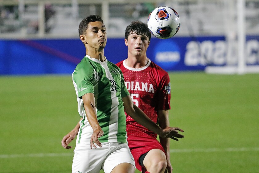 Marshall's Vitor Dias (31) battles with Indiana's Daniel Munie (5) during the first half of the NCAA College Cup championship soccer match in Cary, N.C., Monday, May 17, 2021. (AP Photo/Karl B DeBlaker)