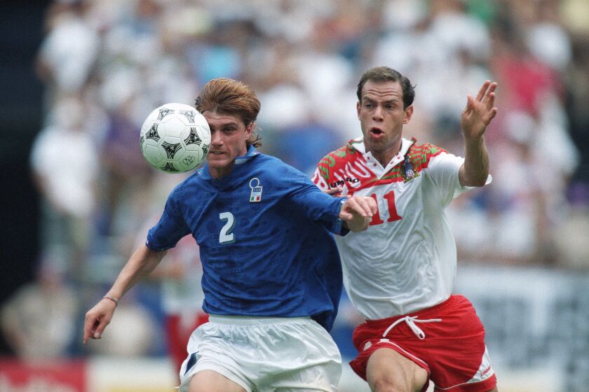 Italy’s Luigi Apolloni, left, fights for control of the ball against Mexico’s Luis Roberto Alves during the World Cup soccer championship Group E game at RFK Stadium in Washington, on Tuesday, June 28, 1994. The game ended in a 1-1 tie, allowing Mexico to advance to the next round of World Cup action. (AP Photo/Doug Mills)