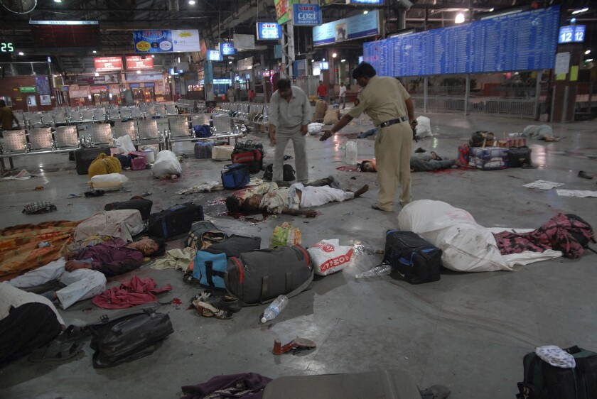 FILE - In this Nov. 26, 2008 file photo, injured commuters and dead bodies lie on the floor at the Chatrapathi Sivaji Terminal railway station in Mumbai, India. Pakistan sentenced Sajid Majeed Mir, 43, one of the militants linked to the 2008 terrorist attacks in Mumbai, India to 15 years in prison for terror financing unrelated to the assaults, according to court documents viewed by The Associated Press on Monday, Jun 27, 2022. (AP Photo/Mumbai Mirror, Sebastian D'souza) INDIA OUT
