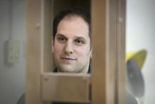 FILE - Wall Street Journal reporter Evan Gershkovich stands in a glass cage in a courtroom at the Moscow City Court, in Moscow, Russia, Dec. 14, 2023. (AP Photo/Dmitry Serebryakov)