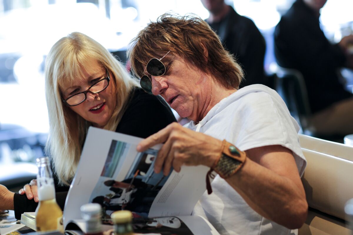 Jeff Beck and actress Candy Clark look through Beck's new coffee table book "Beck01" at Mel's Drive-In in West Hollywood (Jay L. Clendenin/Los Angeles Times)