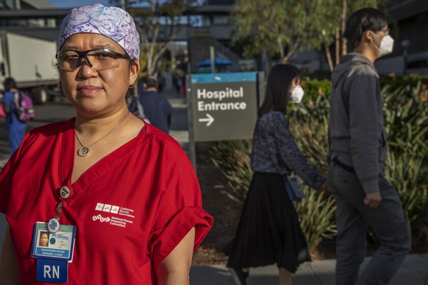 LOS ANGELES, CA - NOVEMBER 20, 2020: Tinny Abogado, 46, a registered nurse at Kaiser Permanente Medical Center on Sunset Blvd in Los Angeles, is photographed outside the hospital, where she has worked for over 20 years. There are concerns in the CA health care system as the third COVID wave crashes over the state. (Mel Melcon / Los Angeles Times)