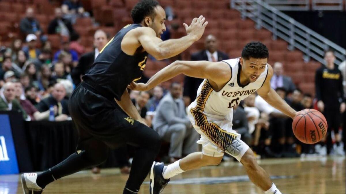 UC Irvine's Jaron Martin drives under pressure by Long Beach State's Evan Payne during the second half of a Big West tournament game on March 10.