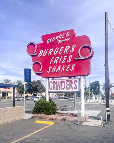 The vintage neon sign of George's Drive In 