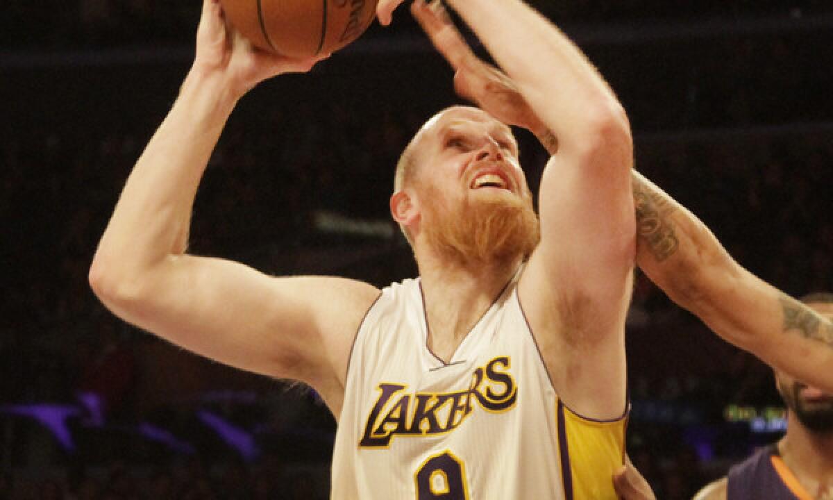 Lakers center Chris Kaman puts up a shot during the team's 115-99 win over the Phoenix Suns at Staples Center on Sunday. Kaman finished with 28 points and 17 rebounds in the win.