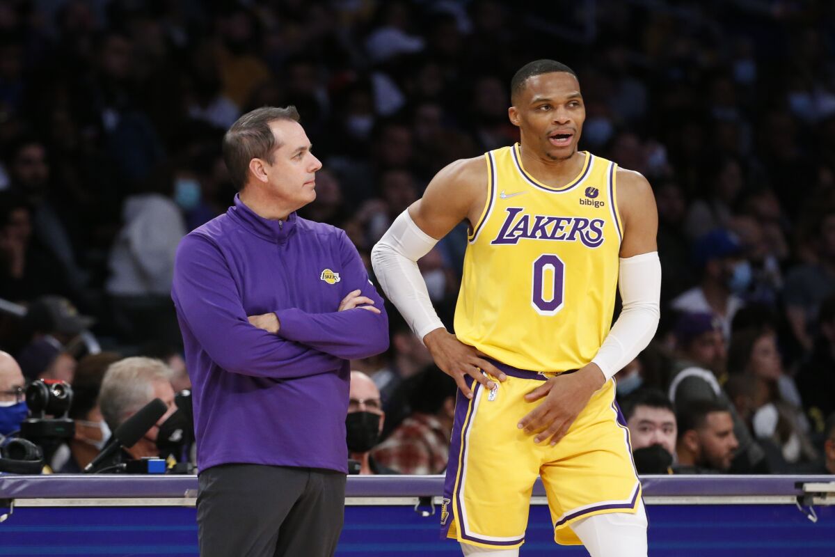 Los Angeles Lakers head coach Frank Vogel confers with guard Russell Westbrook.