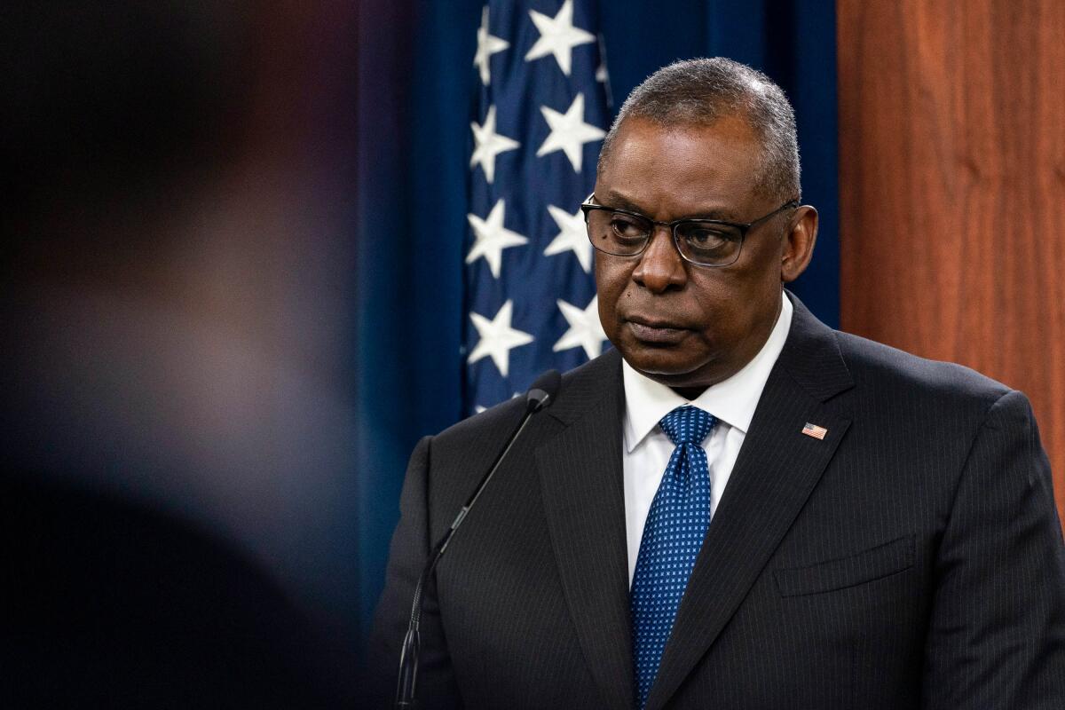 Secretary of Defense Lloyd Austin listens to a reporter's question during a media briefing at the Pentagon