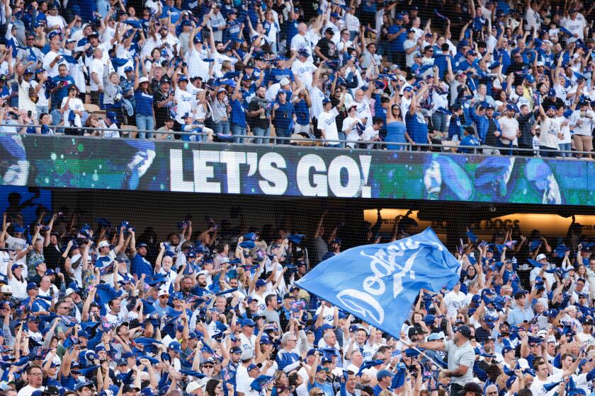 Dodgers fans cheer before the start of Game 6 of the NLCS against the New York Mets at Dodger Stadium on Sunday.