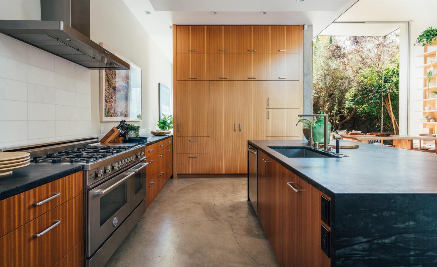 The kitchen has an island, cabinets and appliances.