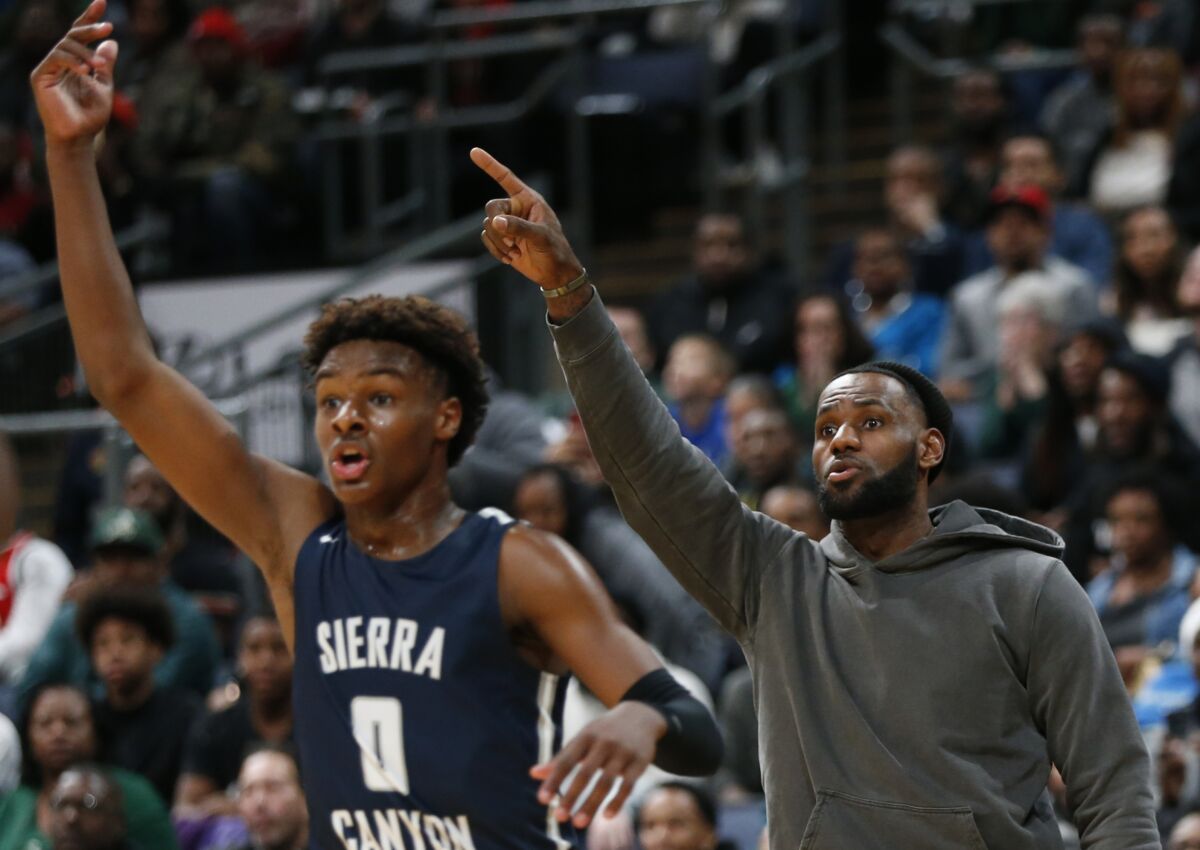 LeBron James reacts from the sideline as his son Bronny (0) plays against his alma mater Saturday night in Columbus, Ohio.