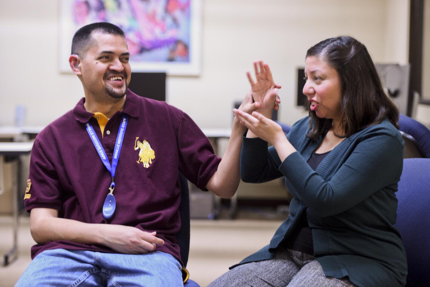 Tania Amaya uses sign language to speak to her husband, Jose.