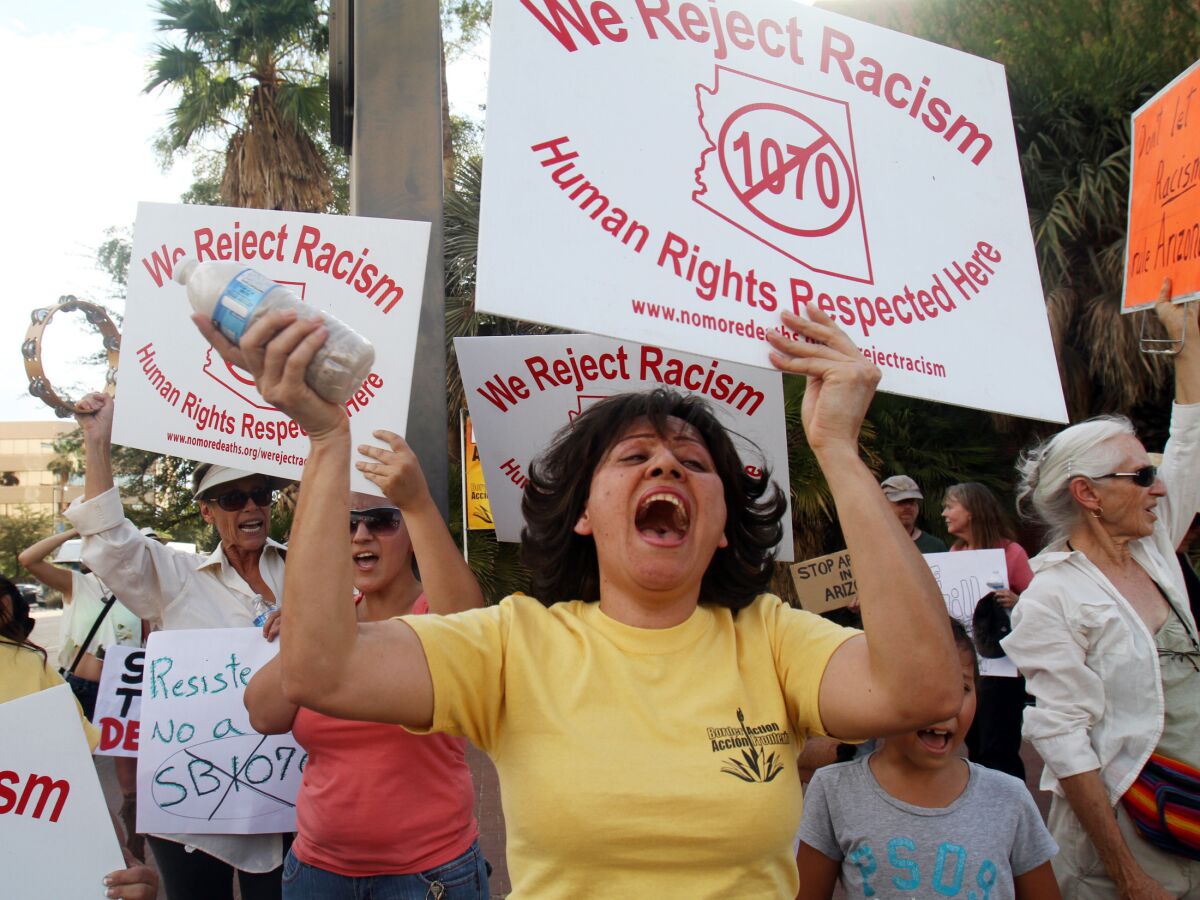 Protesters at the Arizona State Building in Tucson, Ariz., on June 25, 2012 hold a rally after the U.S. Supreme Court's decision on Arizona SB 1070. On Tuesday, Nov. 5, 2019, residents voted not to designate Tucson a “sanctuary city” with further restrictions on how and when police officers can enforce immigration laws. The initiative explicitly aimed to neuter the 2010 Arizona immigration law known as SB 1070, which drew mass protests and a boycott of the state. Courts threw out much of the law but upheld the requirement for officers to check immigration papers when they suspect someone is in the country illegally.