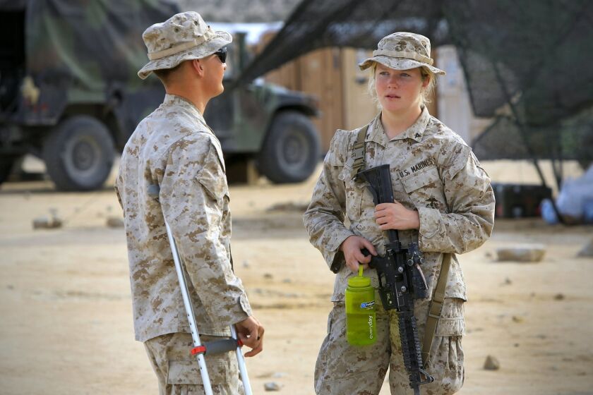 Lance Cpl. Callahan Brown, right, and another Marine in the Ground Combat Element Integrated Task Force, during combat trials to determine if women should serve in ground combat units.