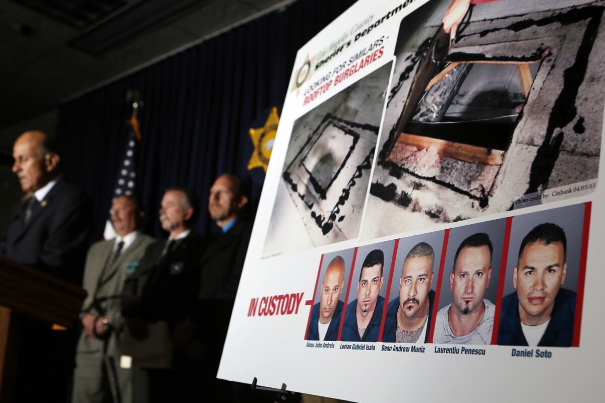 Former L.A. County Sheriff Lee Baca, left, announces in April 2013 the capture of the alleged members of a bank burglary ring that cut through the roofs of bank branches to access their vaults.