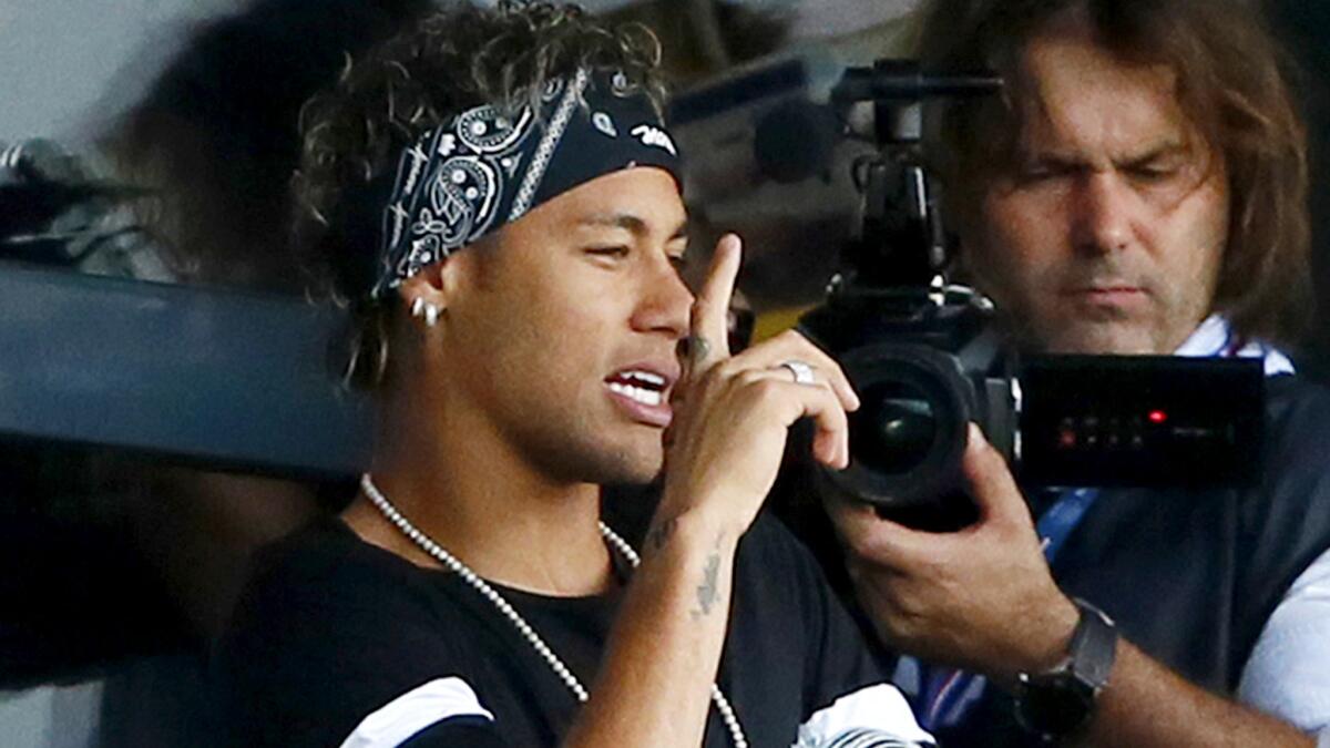 Brazilian soccer star Neymar watches Paris Saint-Germain's season-opening game from a luxury suite Saturday.