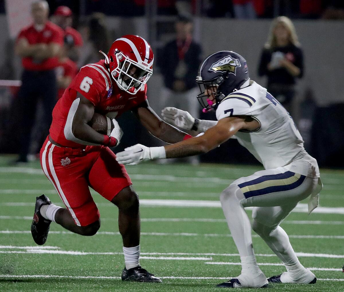 Mater Dei running back Nathaniel Frazier tries to elude St. John Bosco defensive back Peyton Woodyard in a game last season.
