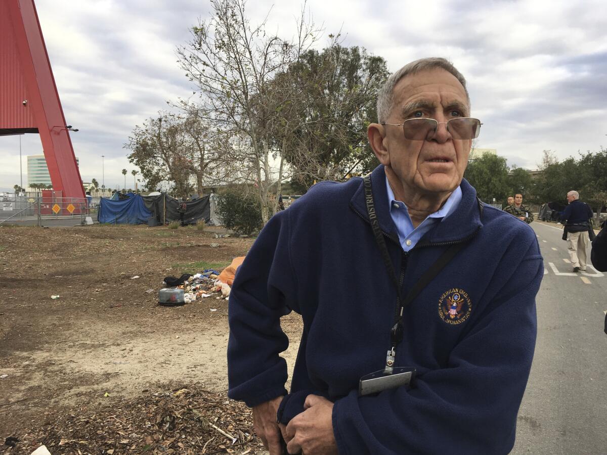 David O. Carter, a U.S. District Judge, tours a homeless encampment in Santa Ana, Calif.