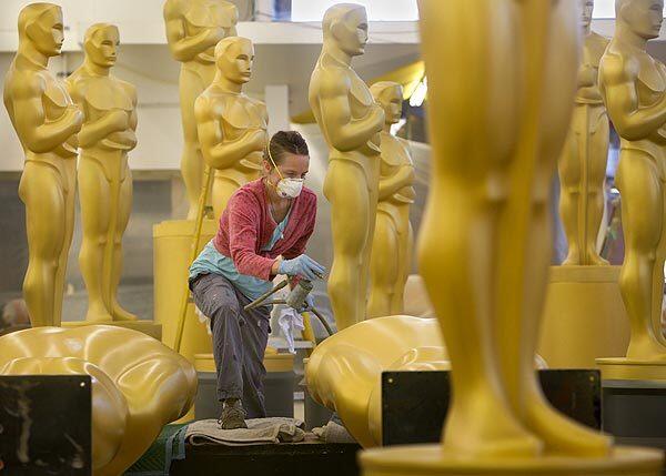 Scenic artist Gayle Etcheverry gives Oscar statues a fresh coat of gold paint on Friday, Oct. 15, 2010, at a secret location in Hollywood ahead of the Academy of Motion Picture Arts and Sciences' Governors Awards next month and the Oscars next year.
