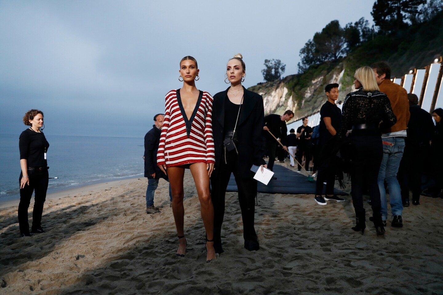Model Hailey Bieber and guest attend the spring/summer 2020 menswear collection show by Belgian designer Anthony Vaccarello for Saint Laurent in Malibu.