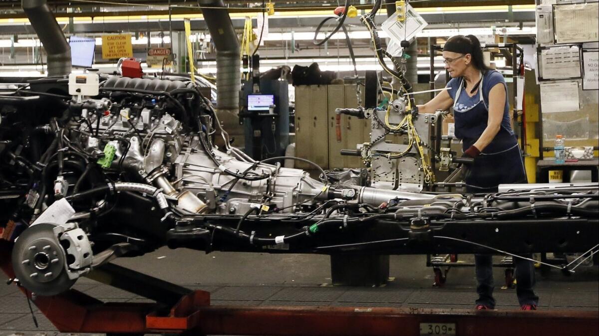 A woman works the assembly line at a General Motors plant in Arlington, Texas. The company, which imports 40% of the vehicles it sells in the U.S., warned Friday that it could shrink U.S. operations and cut jobs if tariffs are applied to imported vehicles and auto parts.