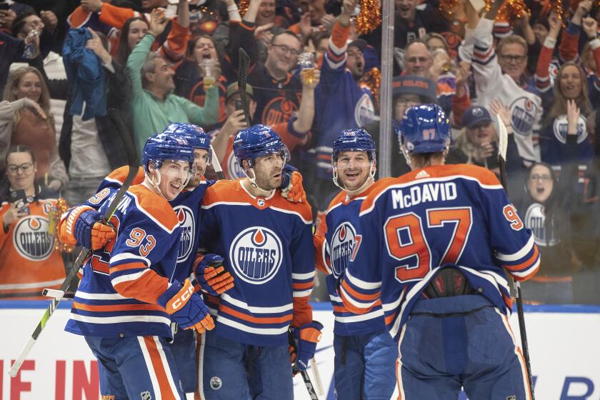Edmonton Oilers' Ryan Nugent-Hopkins (93), Leon Draisaitl (29), Evan Bouchard (2), Zach Hyman (18) and Connor McDavid (97) celebrate a goal against the Los Angeles Kings during the second period in Game 5 of an NHL hockey Stanley Cup first-round playoff series, on Wednesday May 1, 2024, in Edmonton, Alberta. (Jason Franson/The Canadian Press via AP)