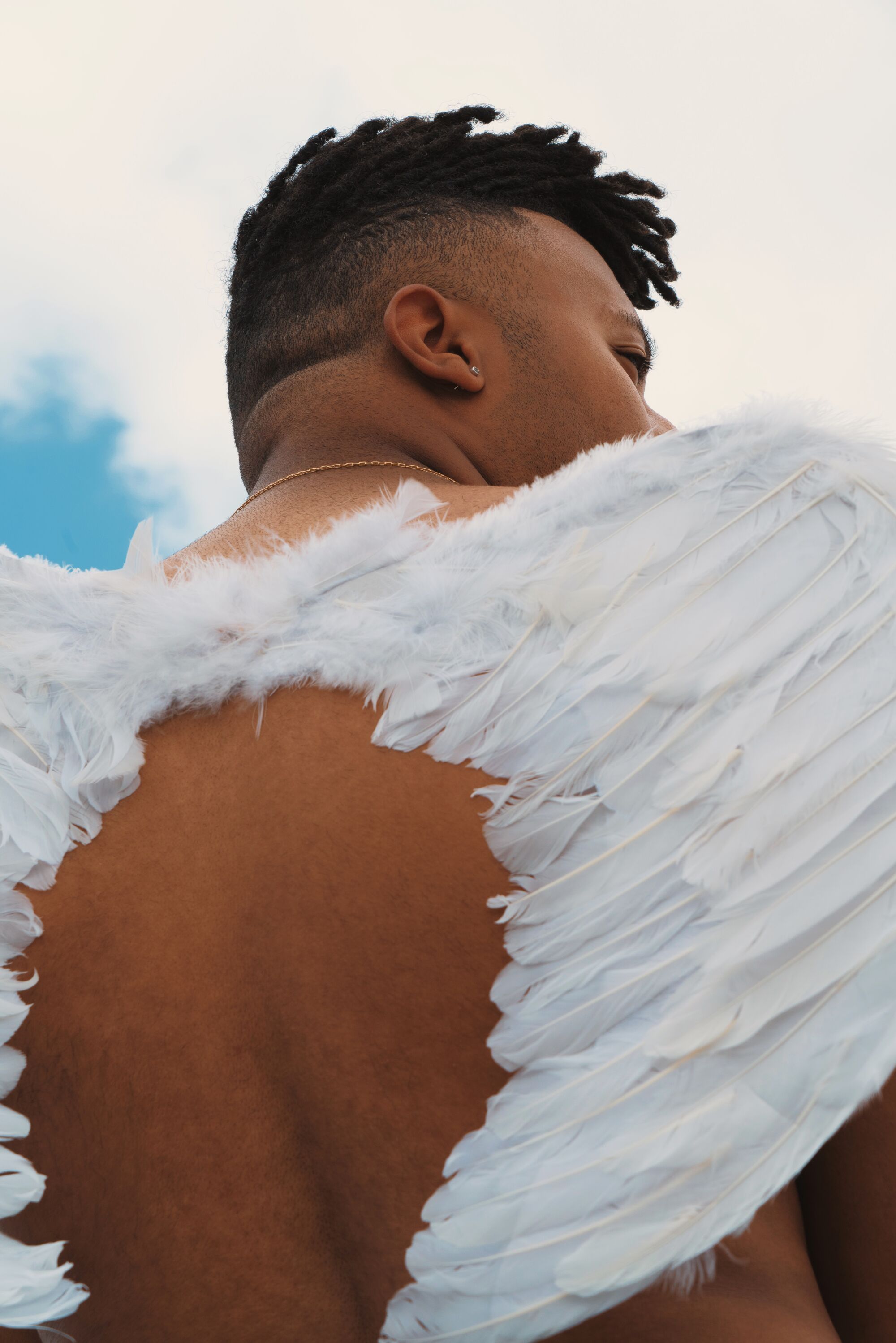 Portrait of Myles Cameron wearing angel wings