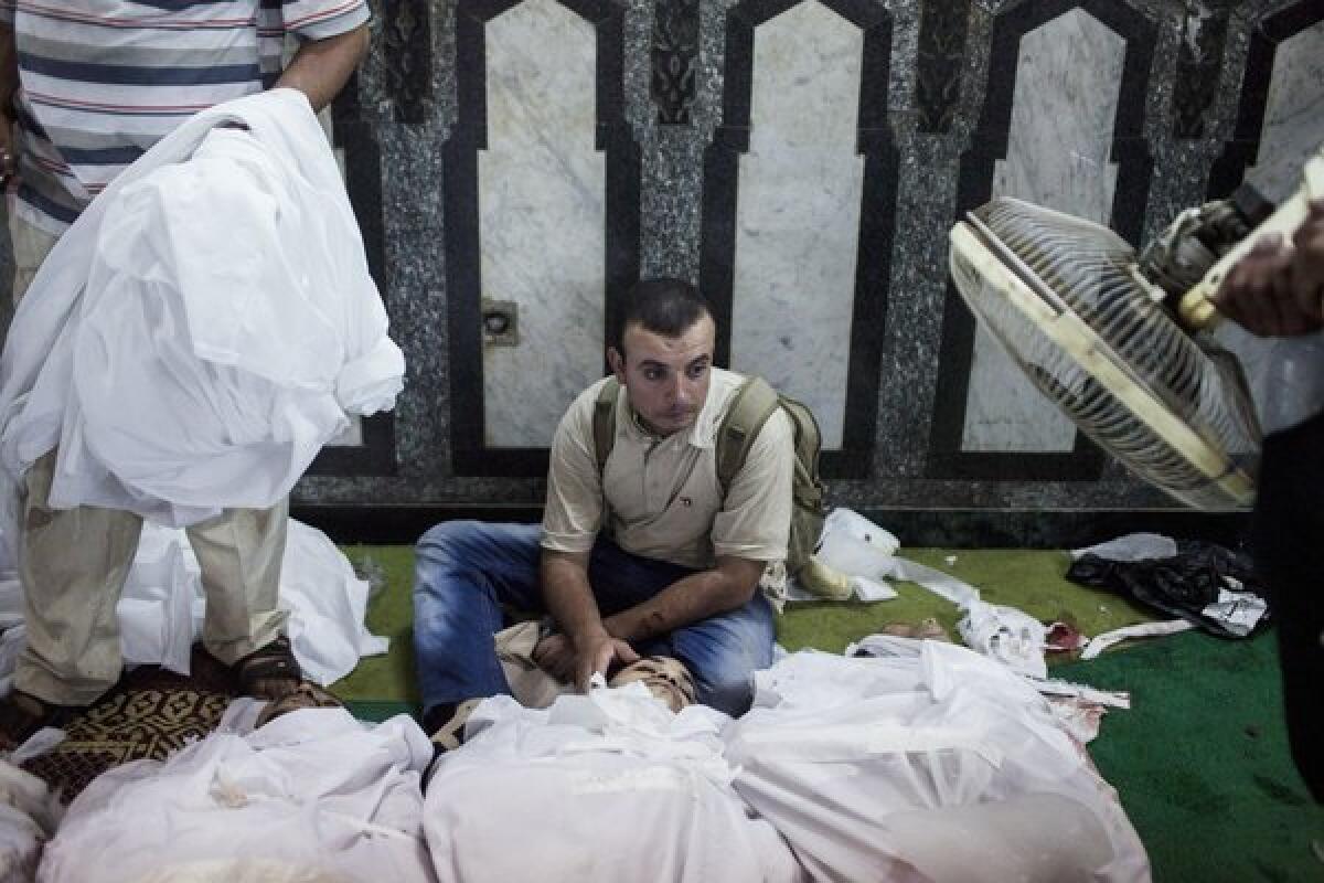 A family member of a supporter of deposed Egyptian President Mohammed Morsi killed during fighting with Egyptian security forces sits in the Fatih mosque in Cairo on Friday.