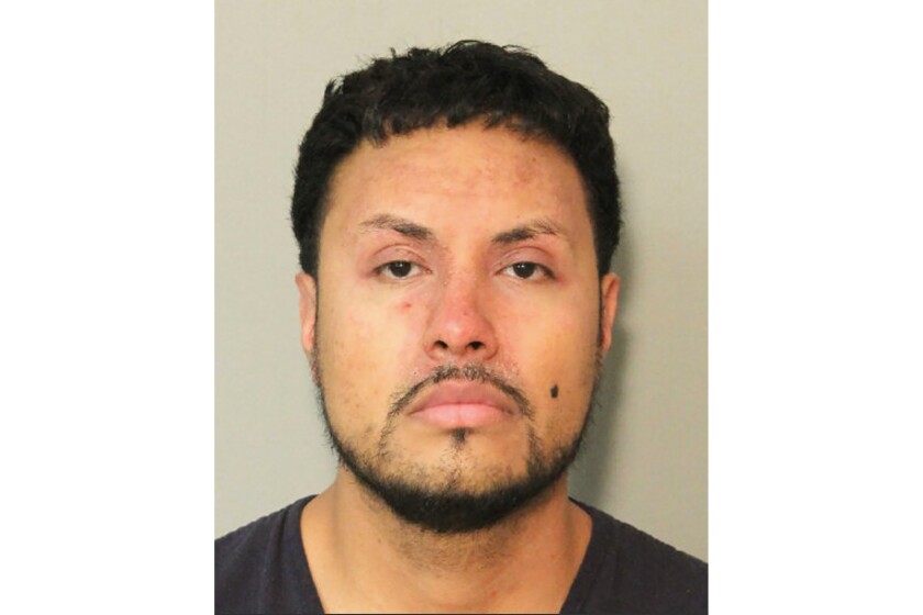 This January 2021 photo provided by the Houston Police Department shows Roland Caballero. Caballero, who was hospitalized in stable condition Friday, Jan. 28, 2022, with a gunshot wound to the neck, has been charged with three counts of attempted capital murder of a police officer and an aggravated robbery count after engaging in a shootout with Houston police after a chase. (Houston Police Department via AP)