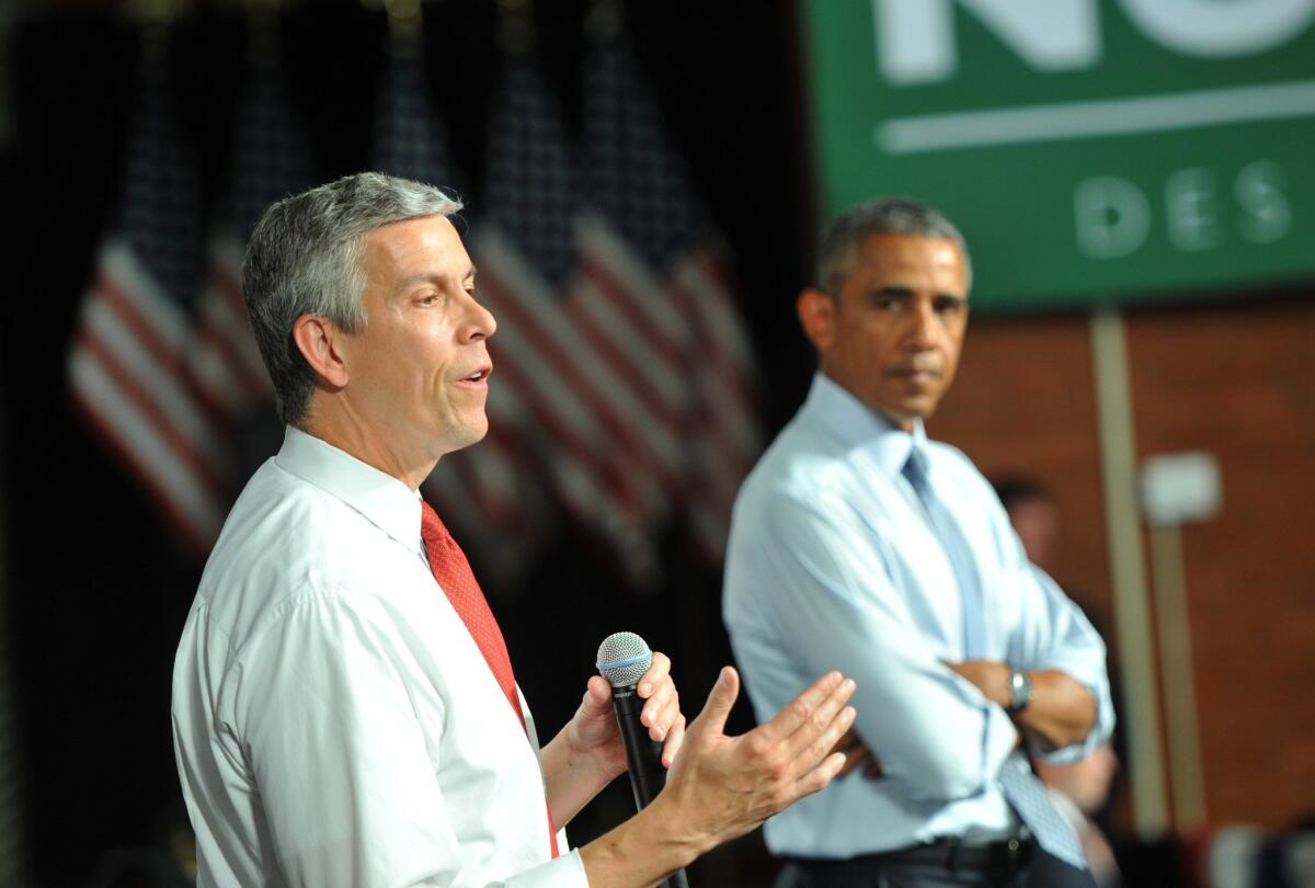 U.S. Secretary of Education Arne Duncan, left, and President Obama attend a town hall meeting in Iowa last month about student loans. Duncan said Friday that he will step down from his post in December.