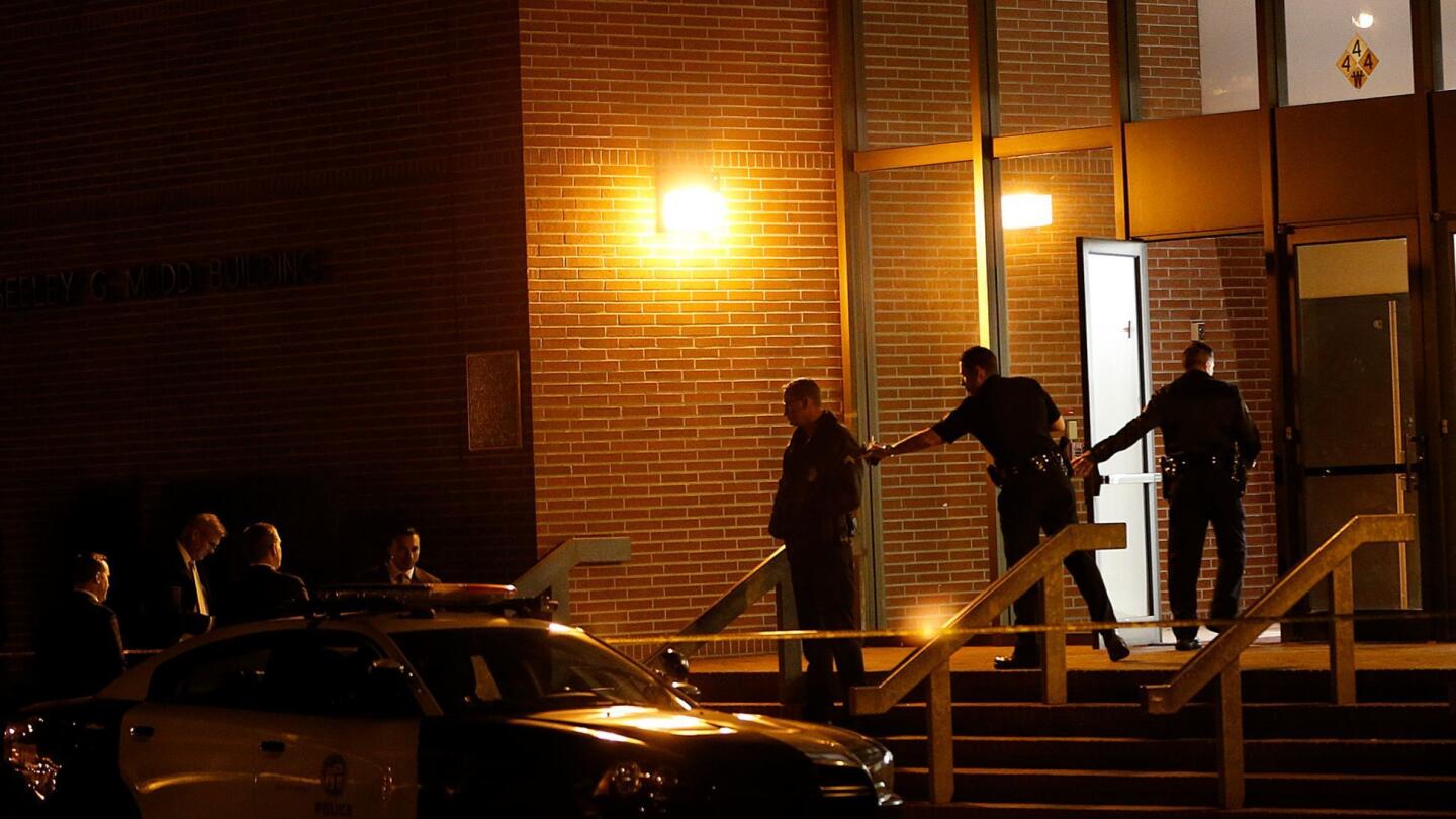 An LAPD officer enters the Seeley G. Mudd Building on the USC campus, where a male professor was stabbed to death.