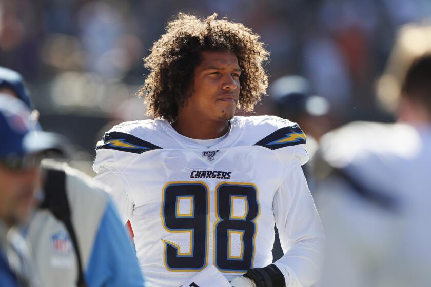 Los Angeles Chargers' Isaac Rochell s5ands on the sidelines during the first half of an NFL football game against the Chicago Bears, Sunday, Oct. 27, 2019, in Chicago. (AP Photo/Charlie Neibergall)