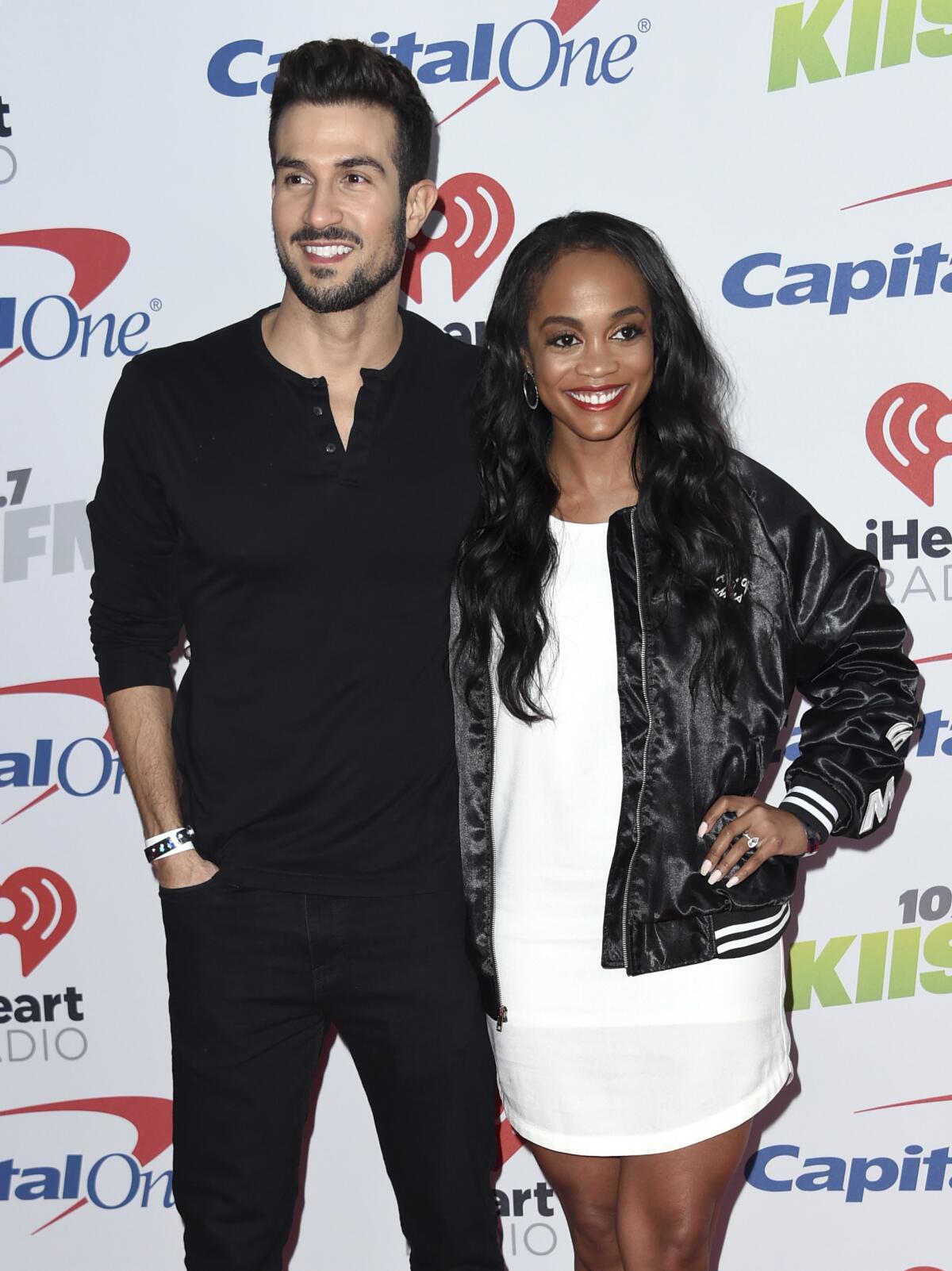 Bryan Abasolo and Rachel Lindsay pose together, smiling, each with an arm around the other. 