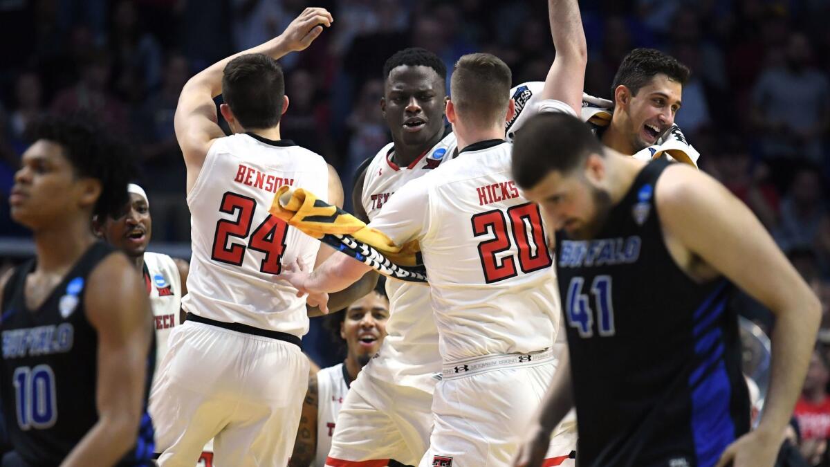 Texas Tech players celebrate their 78-58 victory over Buffalo in the second round of the NCAA tournament.