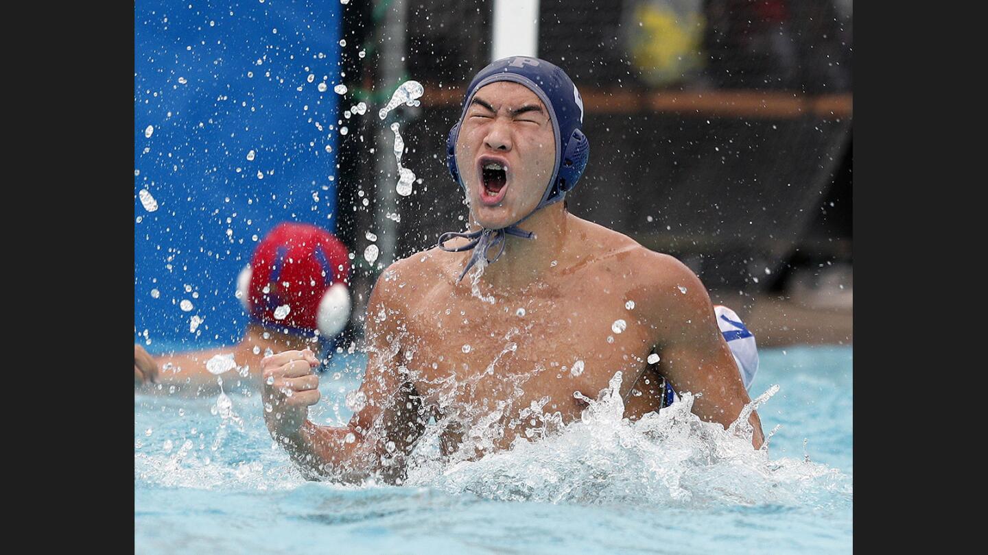 Flintridge Prep's Ian Tien rises high out of the pool and yells "let's go" after scoring against Atascadero in a first-round CIF Southern Section Division III boys' water polo match at Pasadena Polytechnic on Tuesday, October 31, 2017. Flintridge Prep won the match.