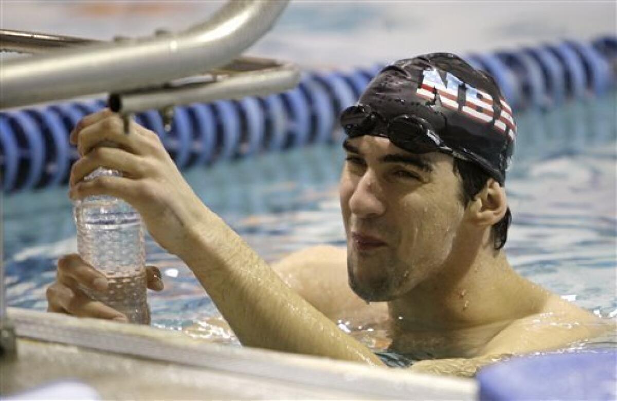 Olympic gold medalist Michael Phelps takes a break while training at the Meadowbrook Aquatic Center, Thursday, Feb. 5, 2009, in Baltimore. (AP Photo/Rob Carr)
