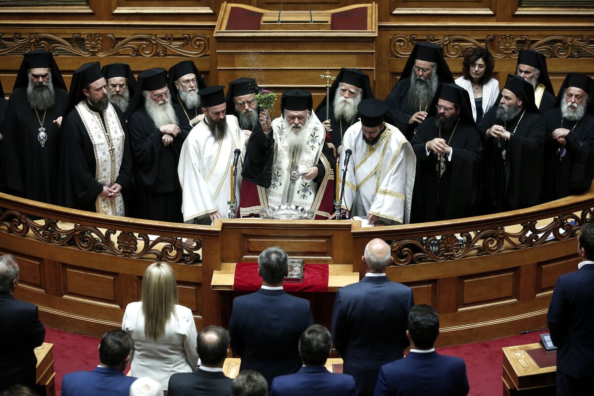 El arzobispo ortodoxo griego Ieronymos, al centro, bendice a los legisladores 